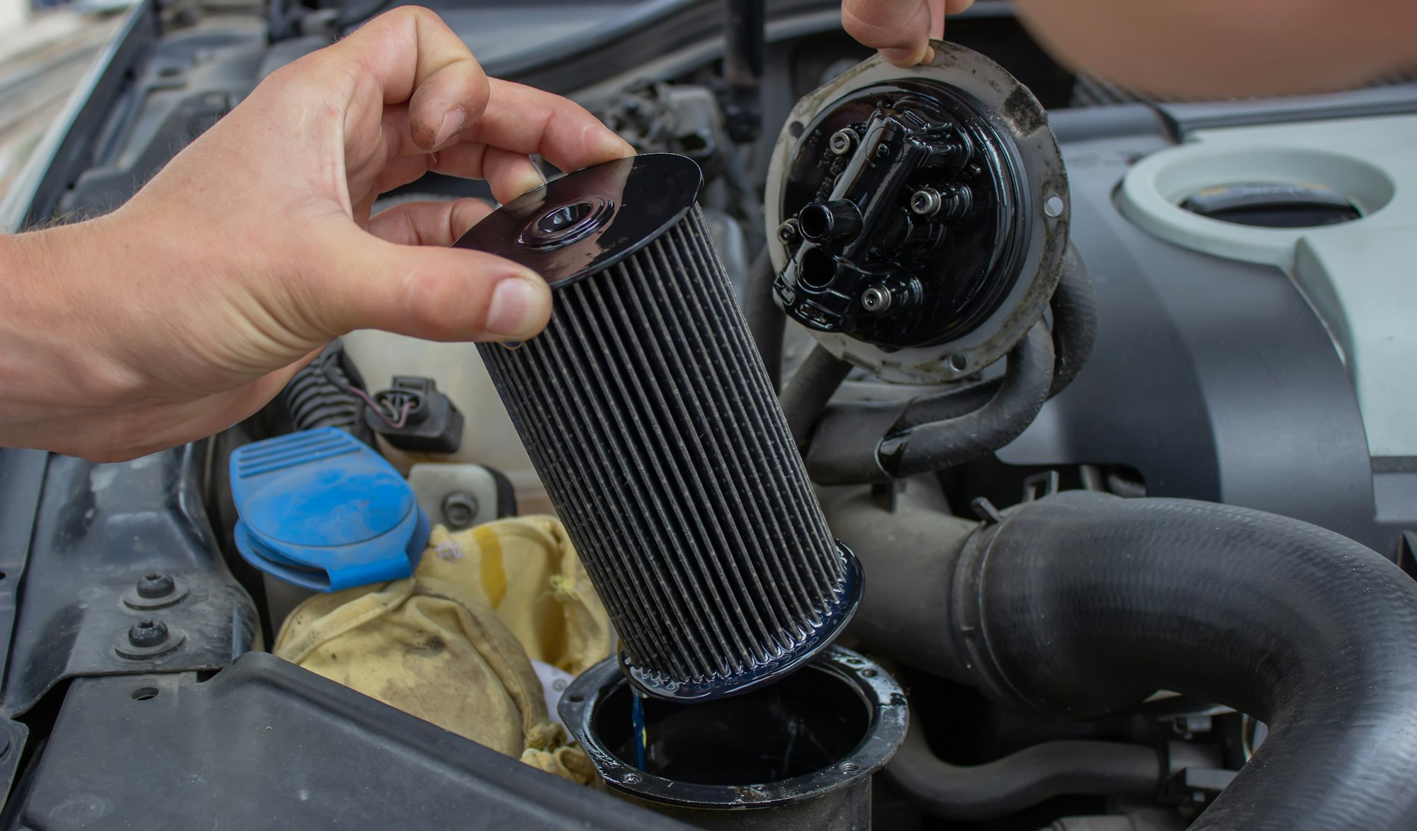 Car repair, fuel filter replacement.