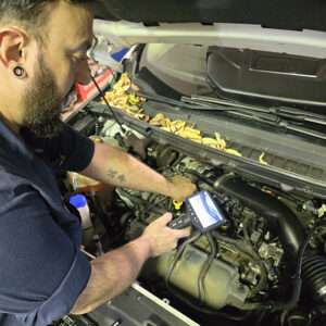 Technician performing diagnostics at HTC Automotive