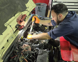 Owner of HTC Automotive inside the Boulder repair shop